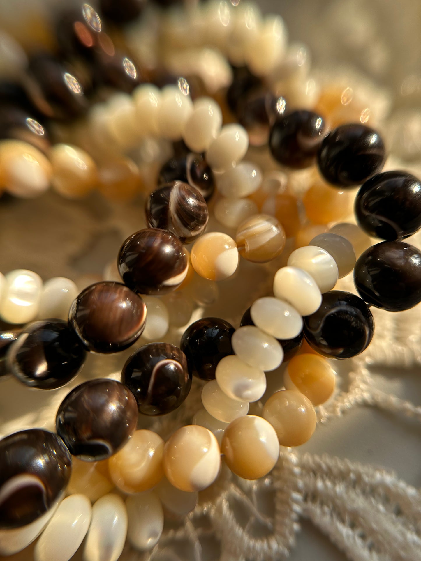 Close-up of a beaded bracelet with black, white, and brown beads.