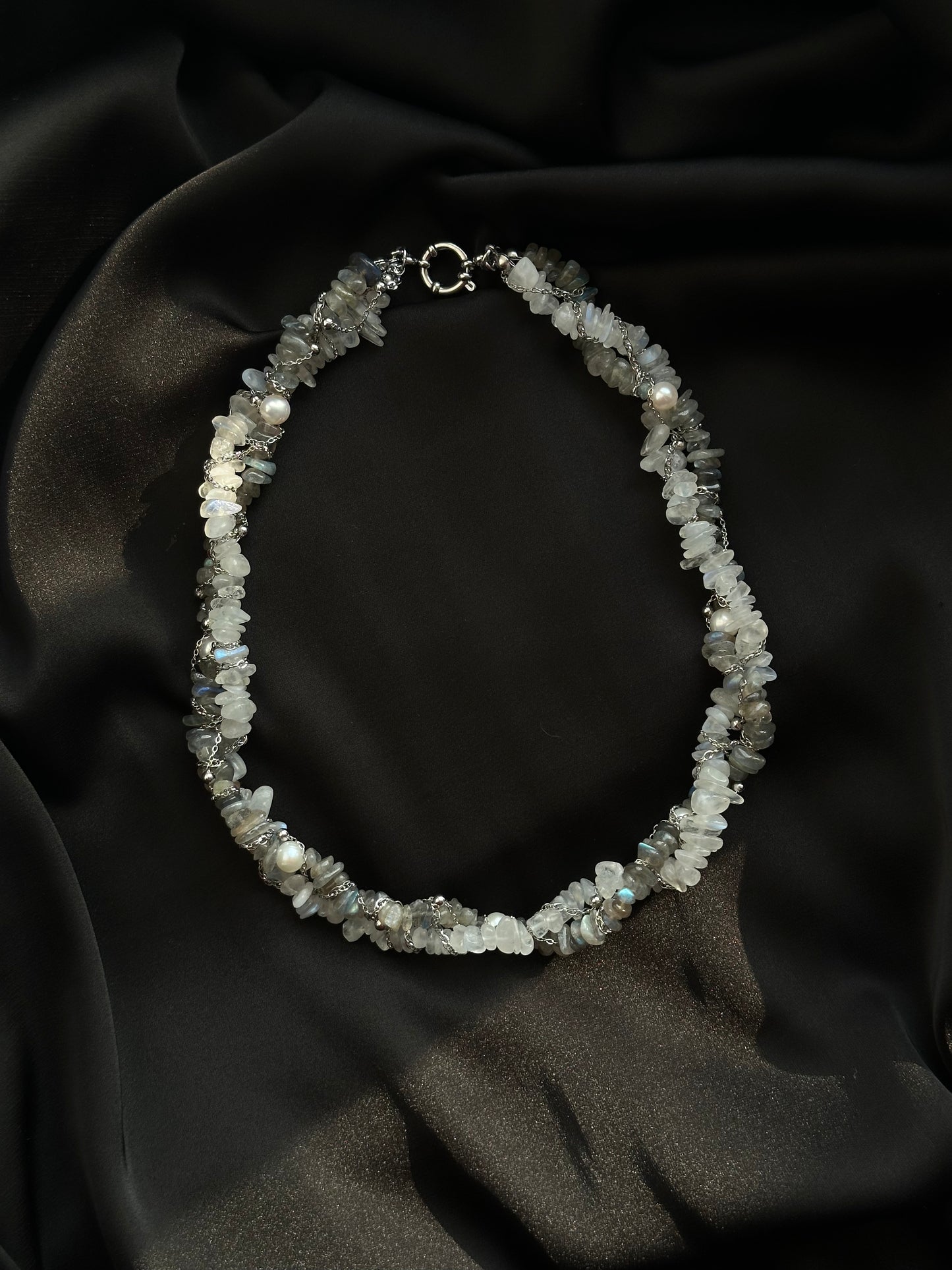 Necklace with clear stones on a dark fabric background