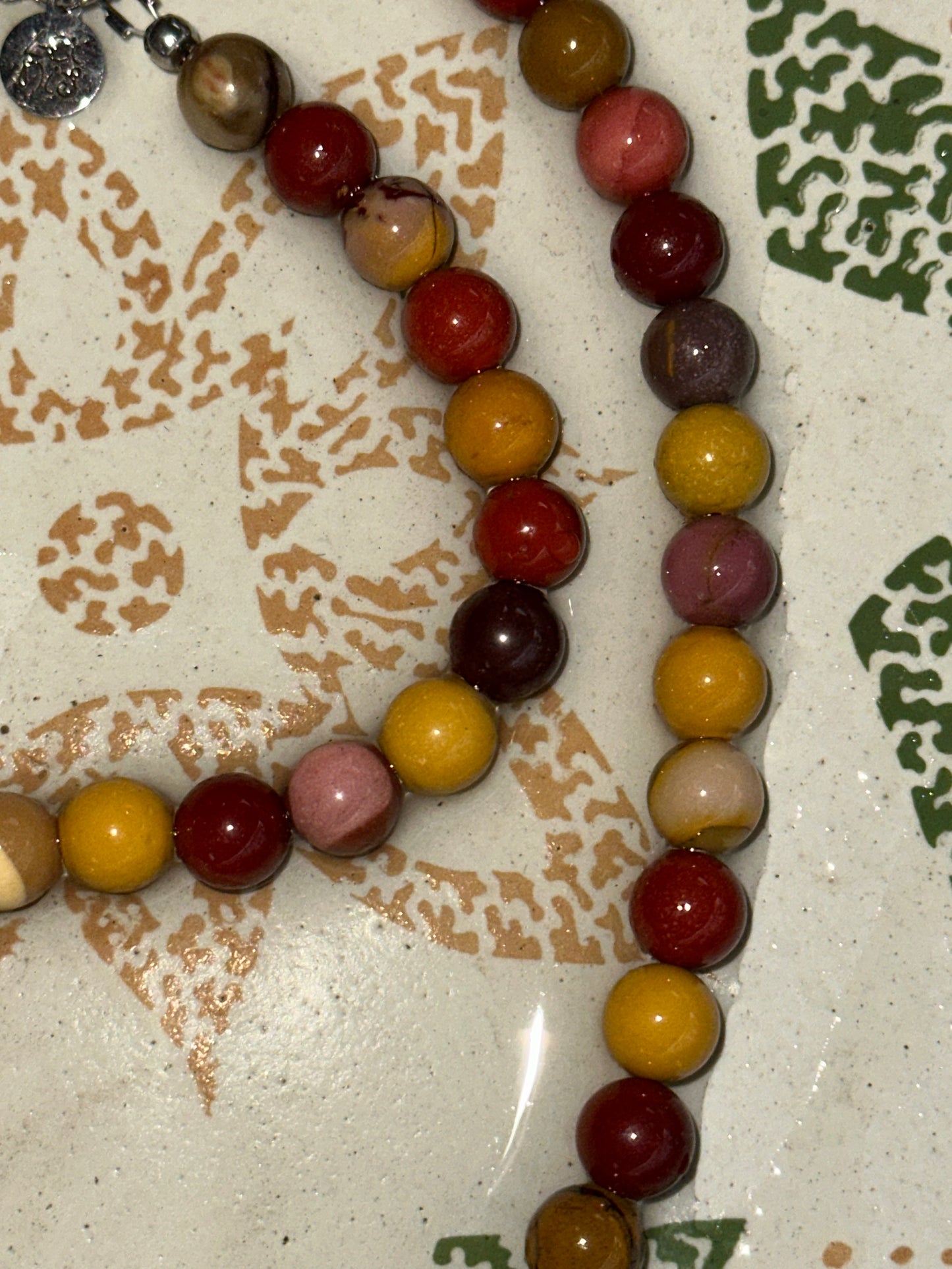 Necklace with multicolored beads on a textured surface
