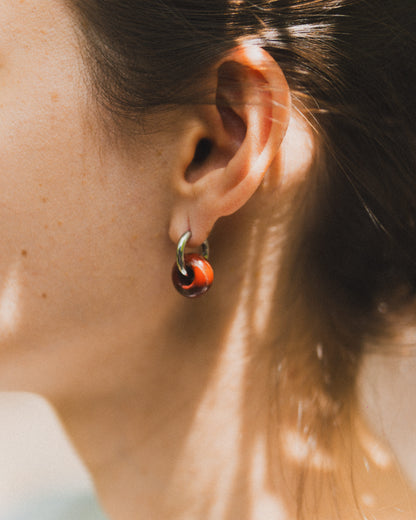 Close-up of an ear with a hoop earring, blurred background